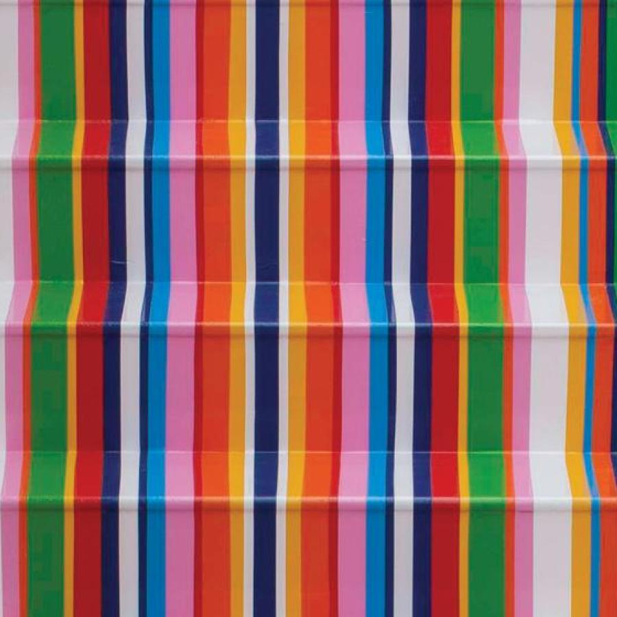 A piece of contemporary art in a gallery - a set of stairs that have been decorated in vertical stripes in various colours including green, orange, blue and yellow