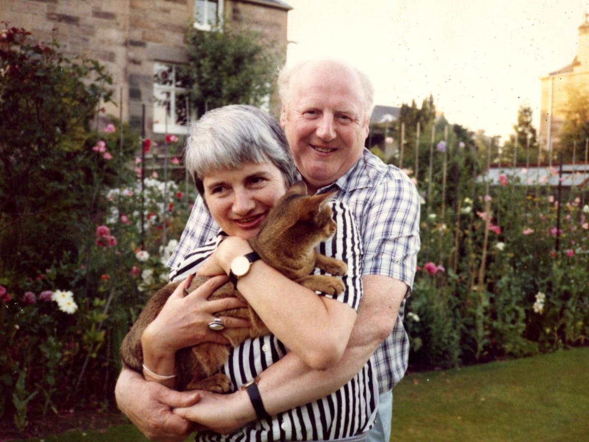 A photo of Elizabeth Blackadder and John Houston, Elizabeth is holding a cat.