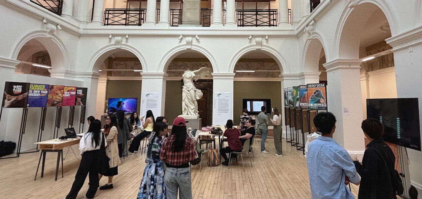 an exhibition of digital art in the sculpture court of Edinburgh College of Art, filled with students discussing the work