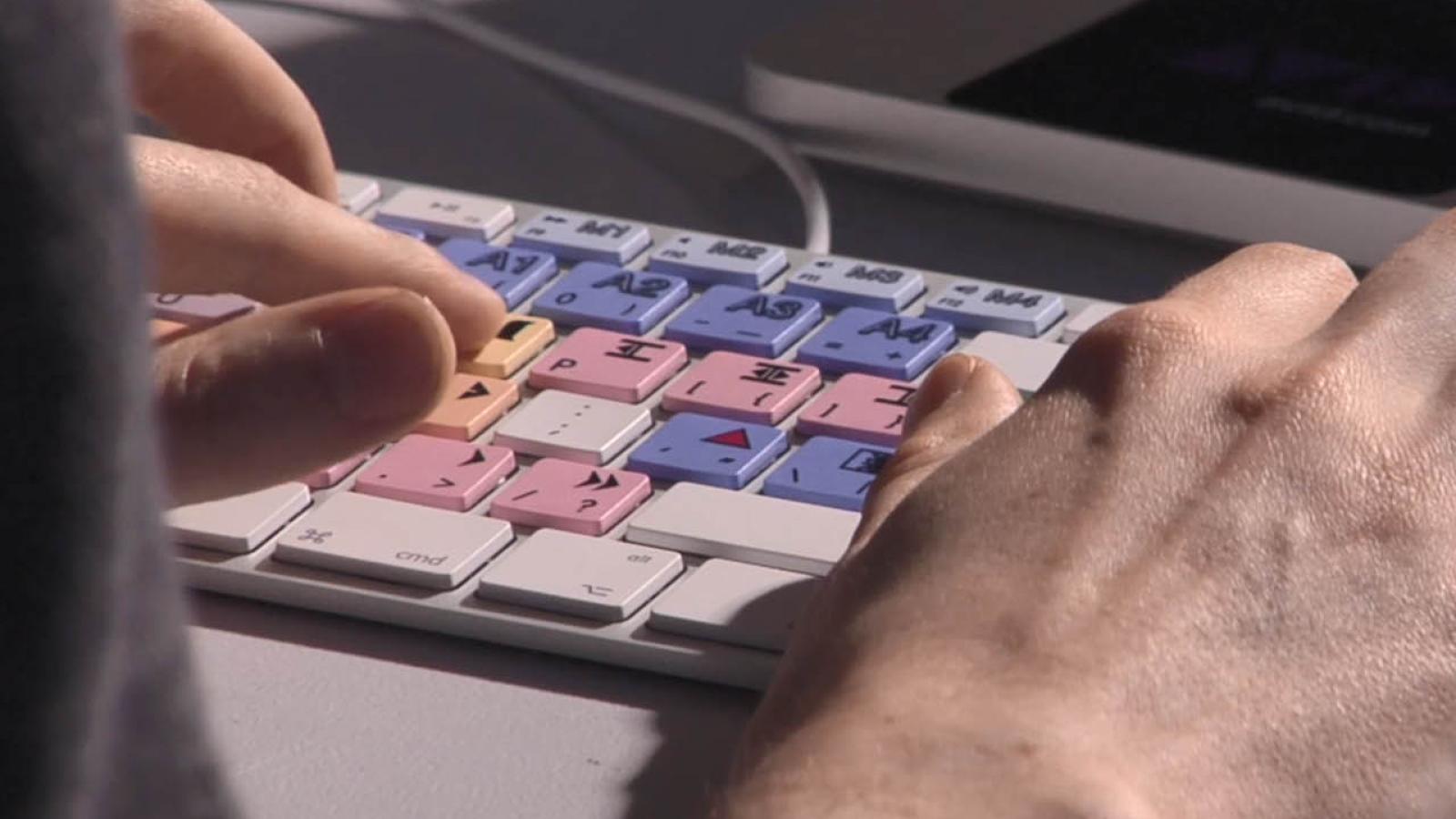 Close-up of a video editing keyboard in use