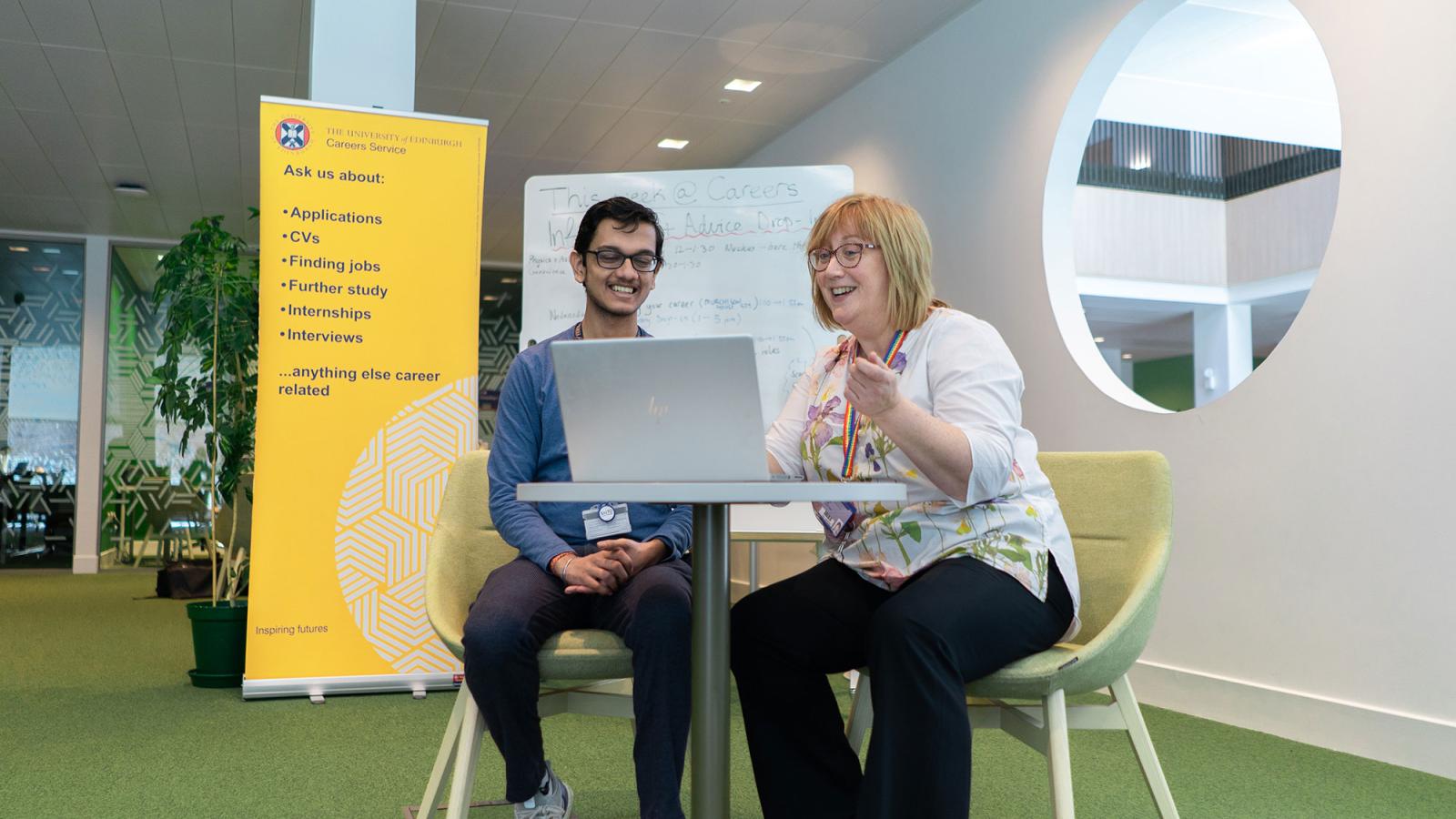 A member of staff giving a student careers advice