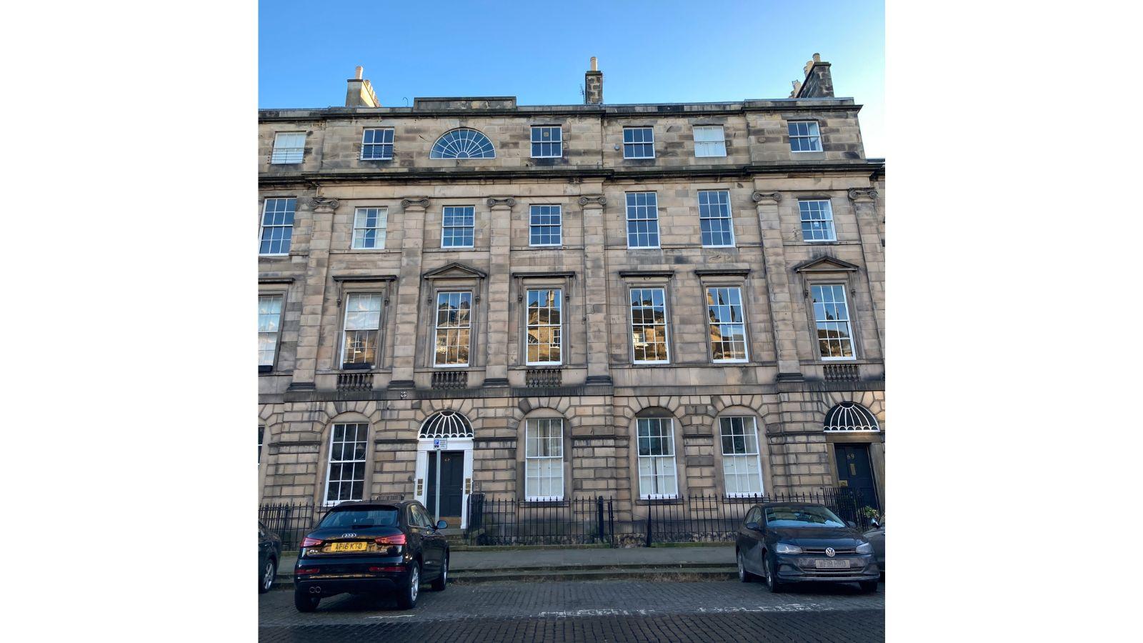 A photograph of a terrace in Edinburgh's New Town, showing a variety of shapes and styles of window
