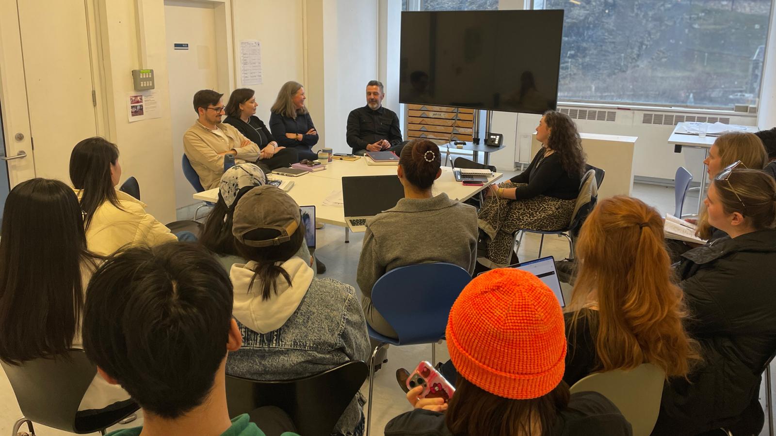 A group of Interior Design undergraduate students attend a presentation by four industry mentors