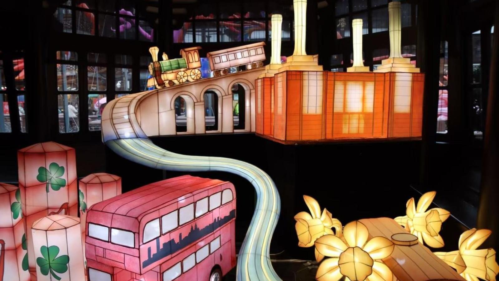A dramatic and colourful display of the lanterns which includes one inspired by a red London double decker bus.