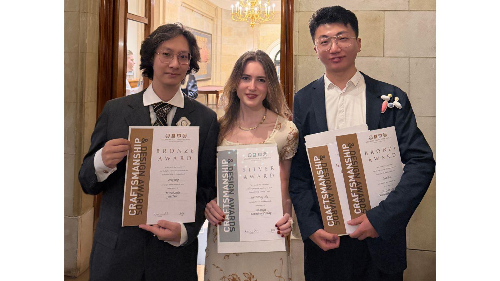 Dong, Isabel and Mervin, smartly dressed, hold their certificates