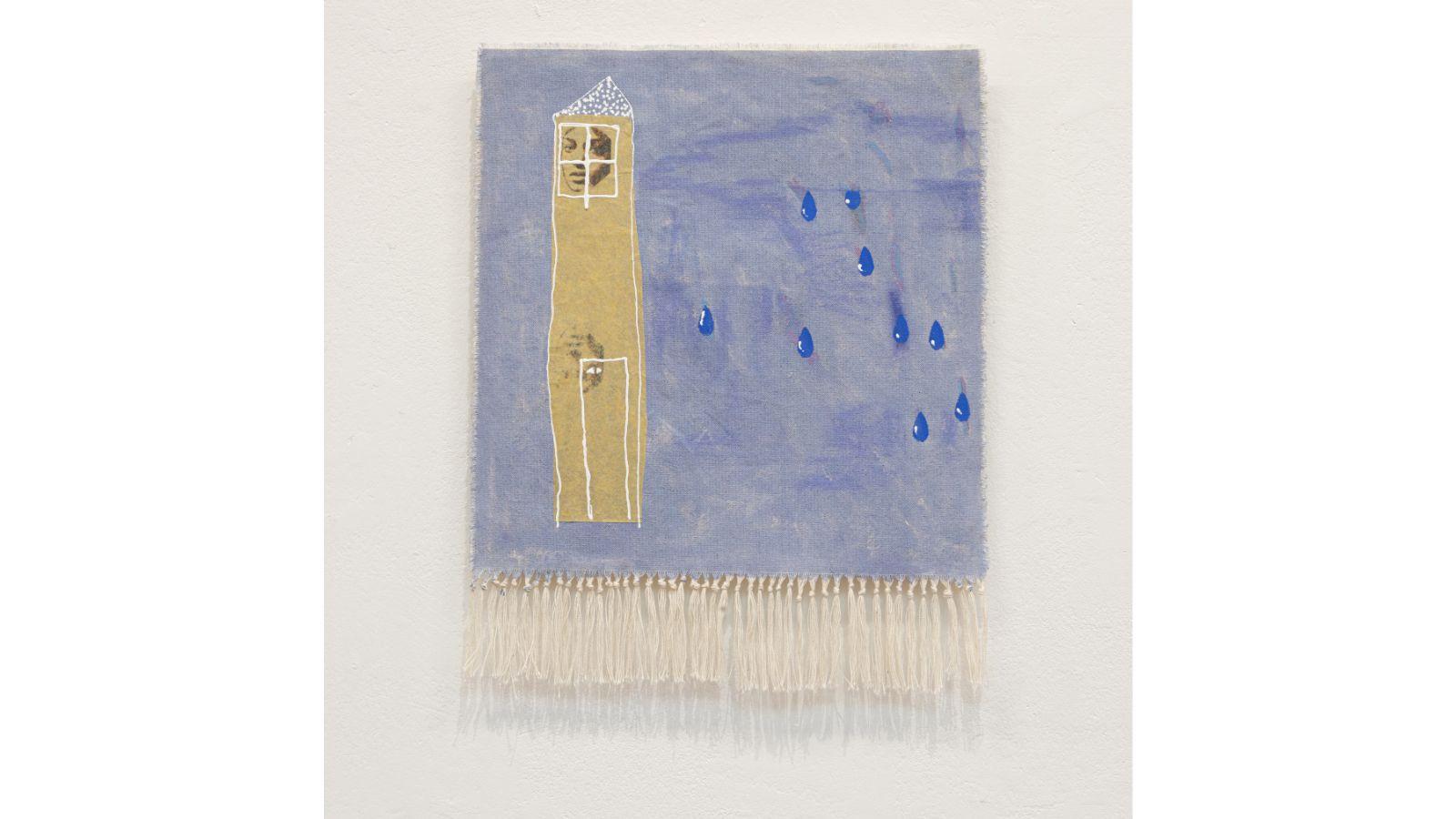 A canvas with knotted tassels at the bottom. The canvas is painted a textured, pale blue, with several large drops in a darker blue. There is a tall, thin, sandy-coloured tower with a large face appearing in a window at the top. 