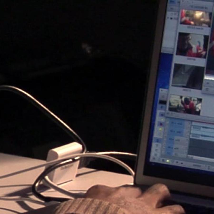 A close-up showing someone editing a video on a computer