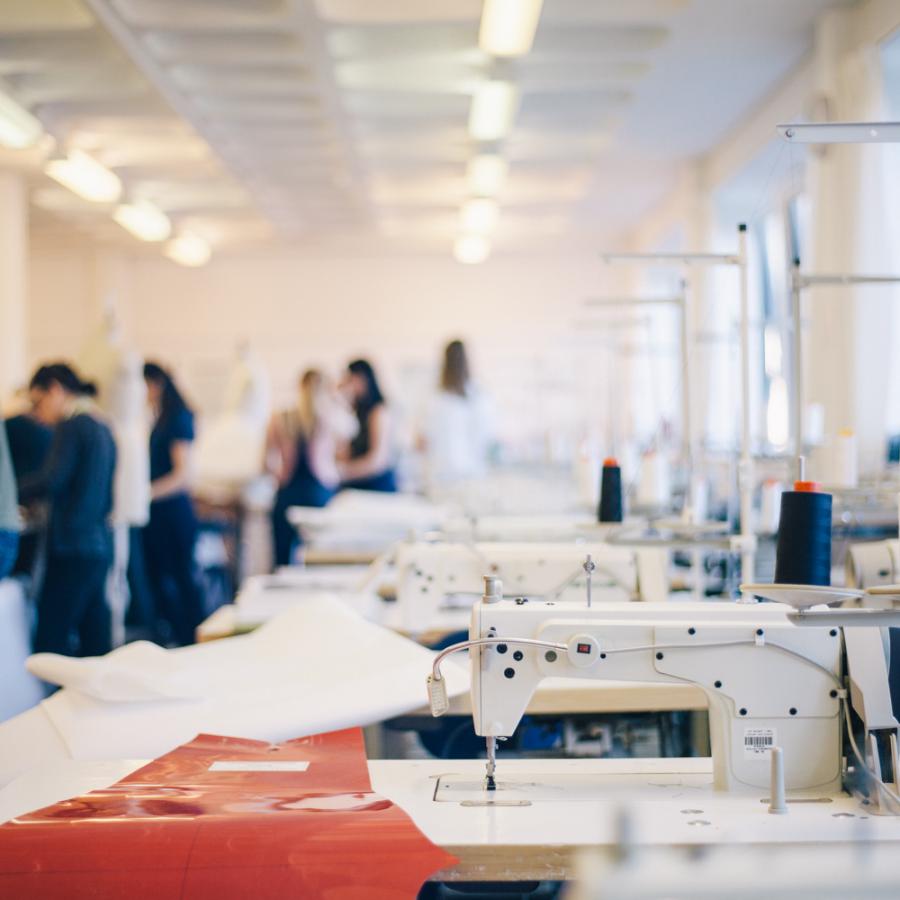 A fashion workshop filled with sewing machines and fabric