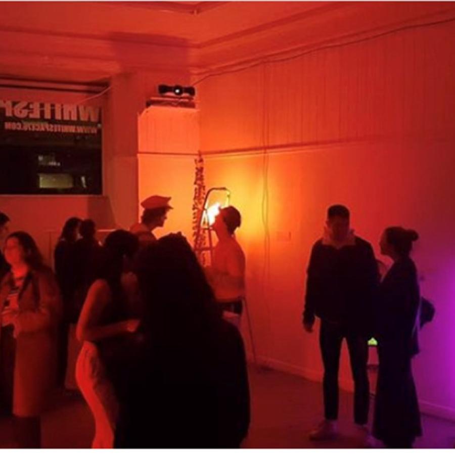 People gathered in a room with fluorescent lights