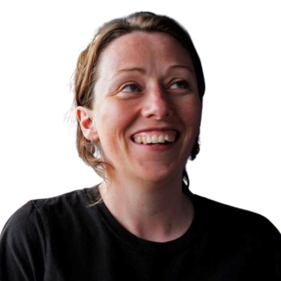 A head and shoulders photograph of Sue. She's wearing a black top, smiling and looking up towards the top right of the image