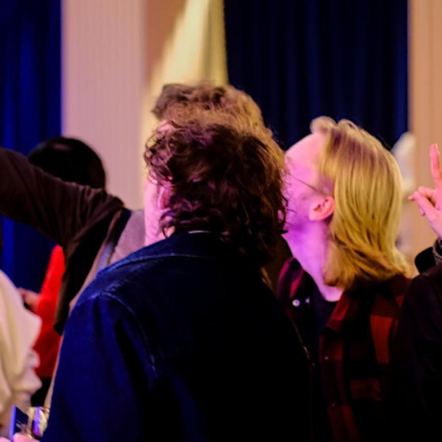 A group of students posing for a photo at an event in the Talbot Rice Gallery. 