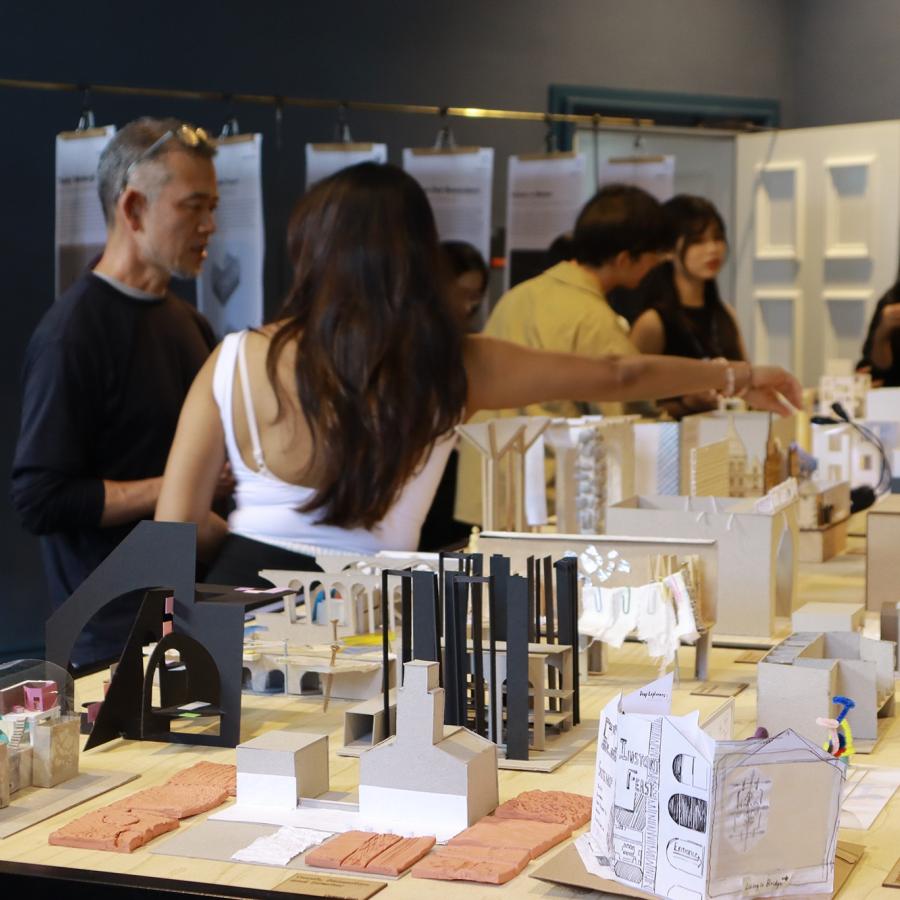 lively discussion around a table of models 