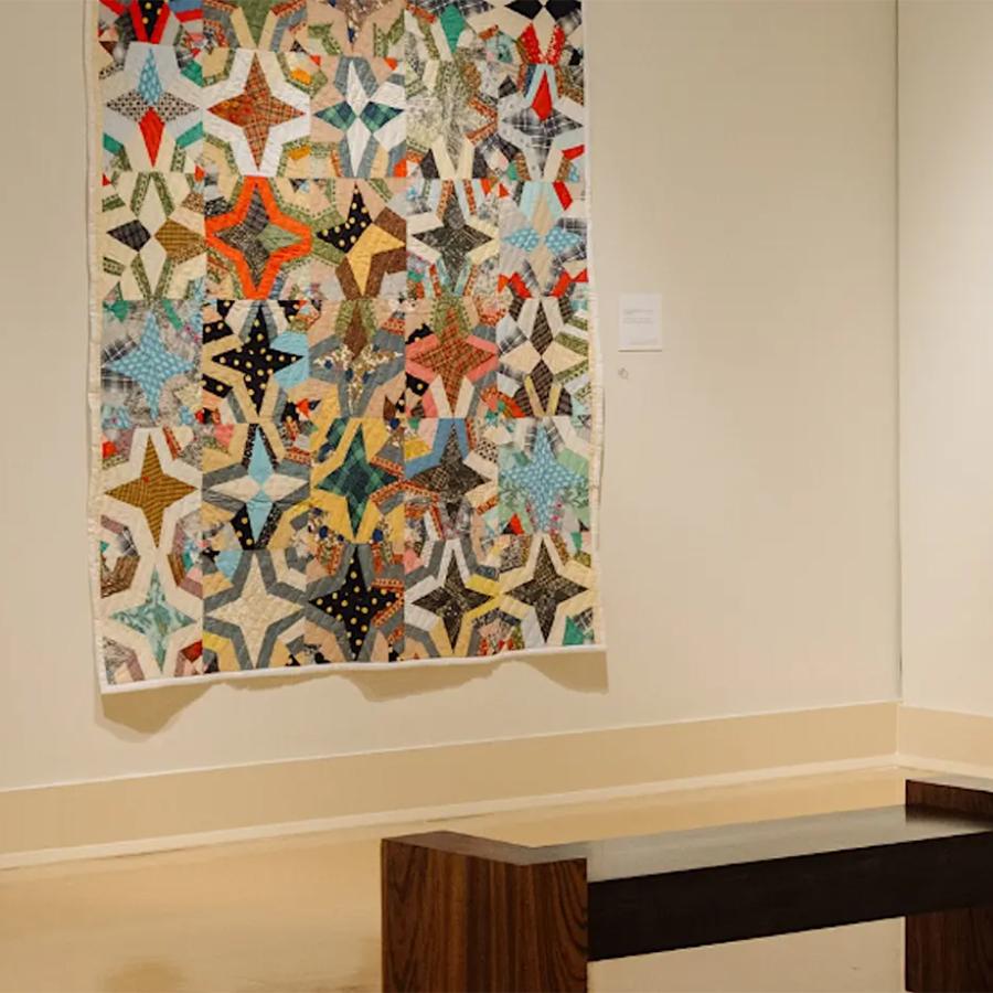 A corner of the exhibition, Of Salt and Spirit: Black Quilters in the American South, Mississippi Museum of Art 2025, featuring two quilted pieces of work.