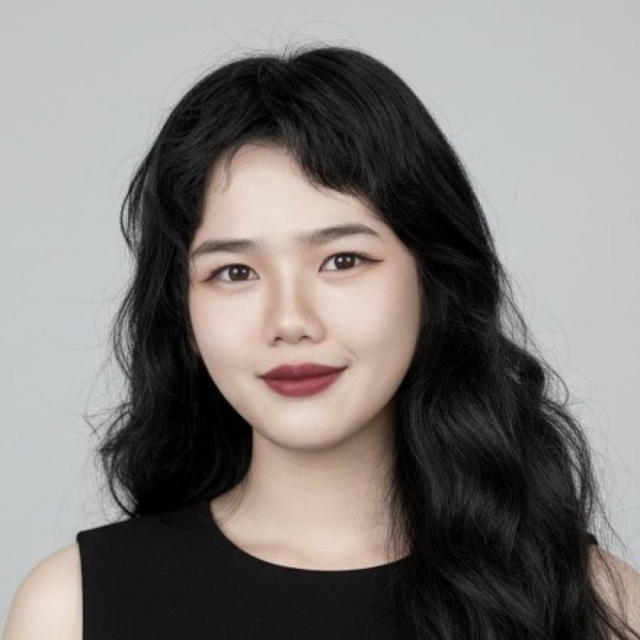 Jiarong Yu smiles to the camera. They're wearing a black, sleeveless top, have wavy black hair, and wear a red lipstick.