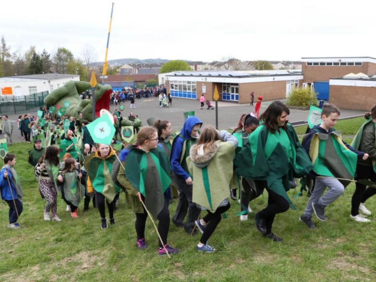 Children on a parade with an inflatable dragon