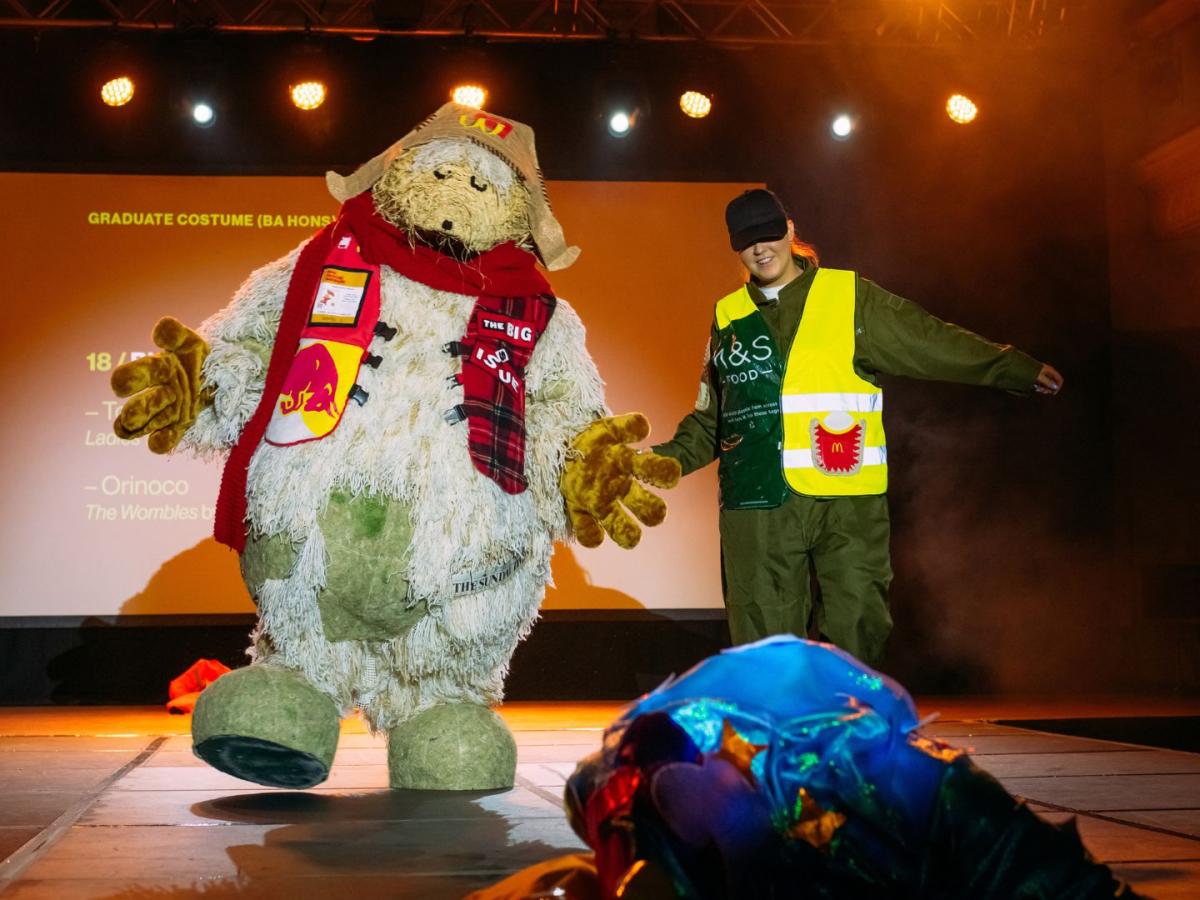 A photo of Orinoco from the Wombles costume on stage at the Performance Costume Show 2023, led by designer Biz Sutton