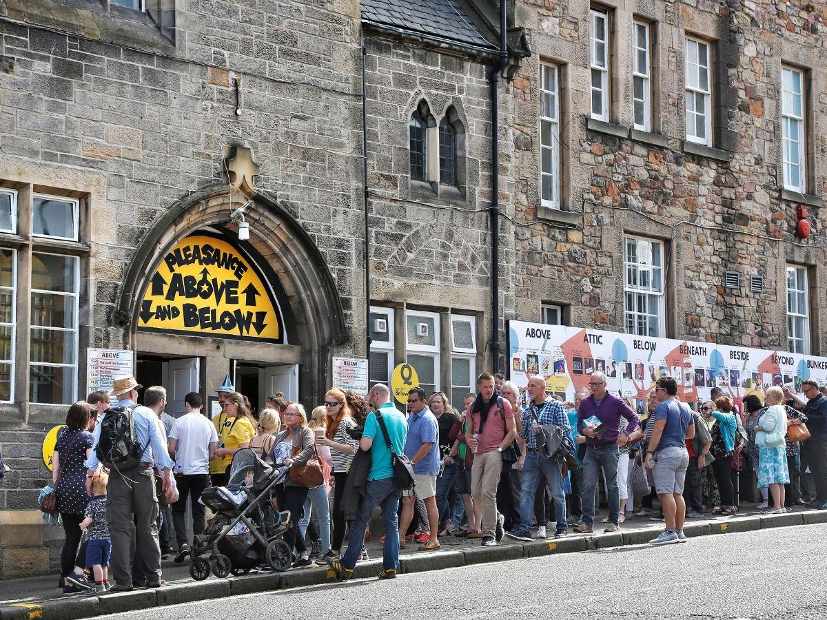 A line of people, queuing outside The Pleasance, during the Fringe 