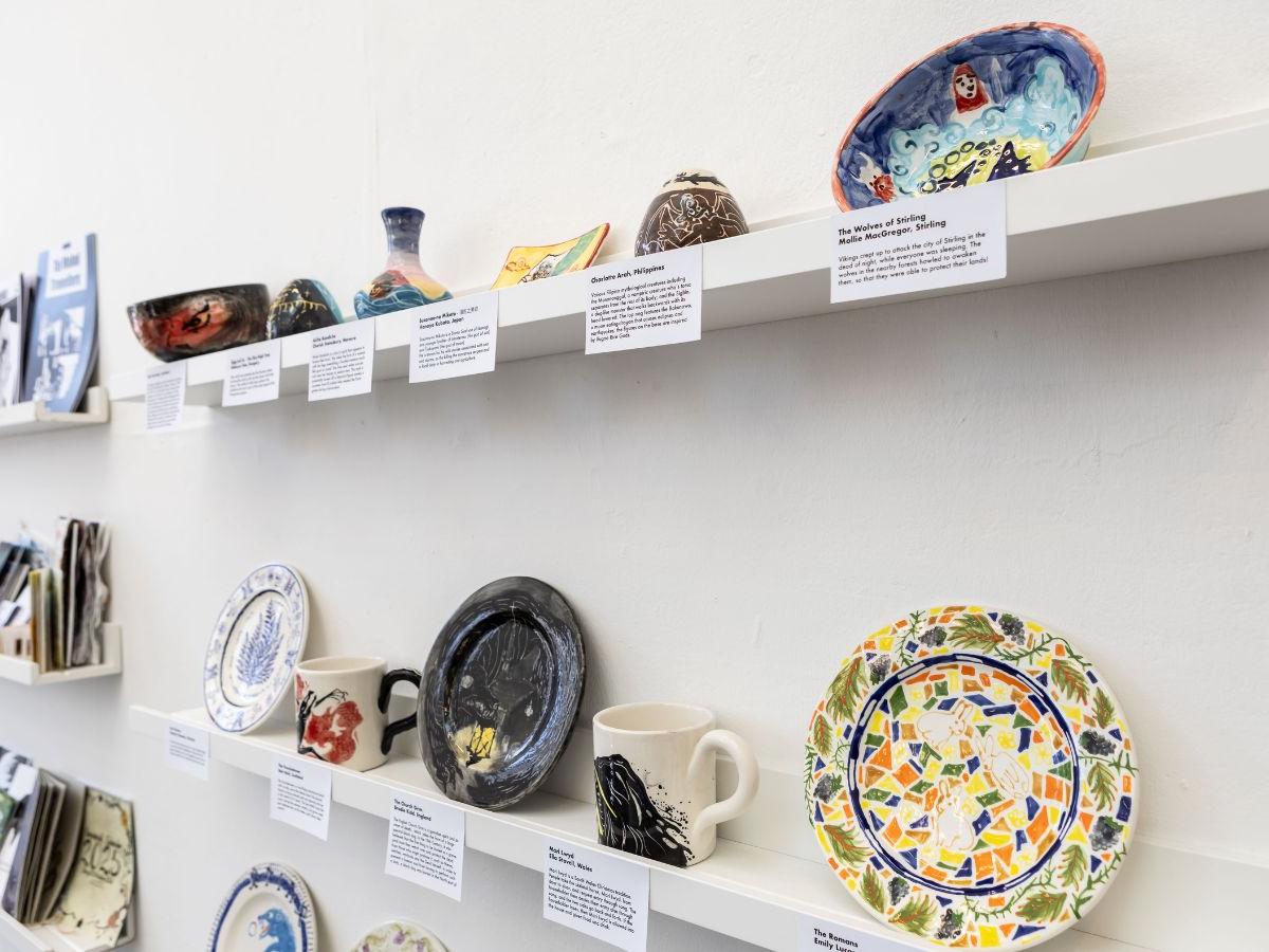 A shelf with a selection of ceramics of it, of different sizes and shapes