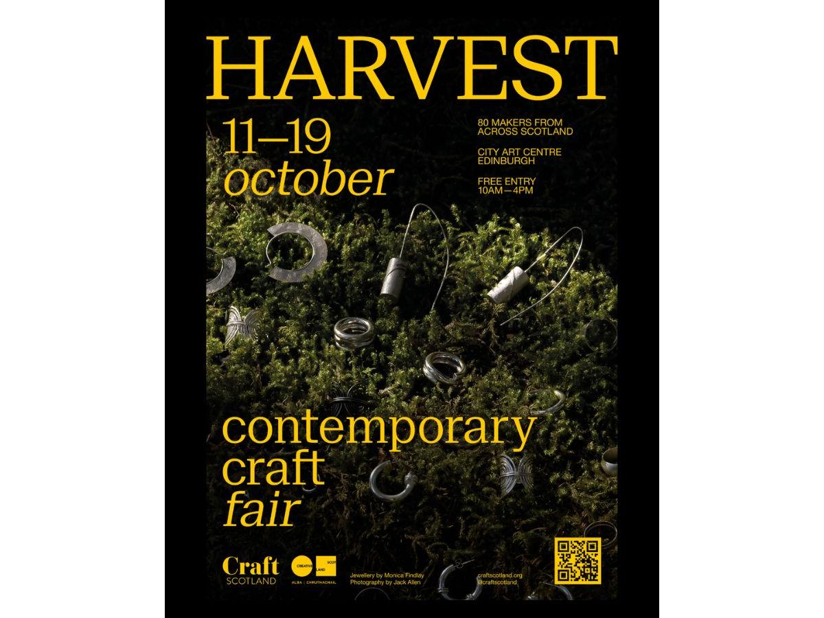 Poster for Harvest Contemporary Craft Fair. The images shows silver-coloured jewellery lying on a bed of moss.