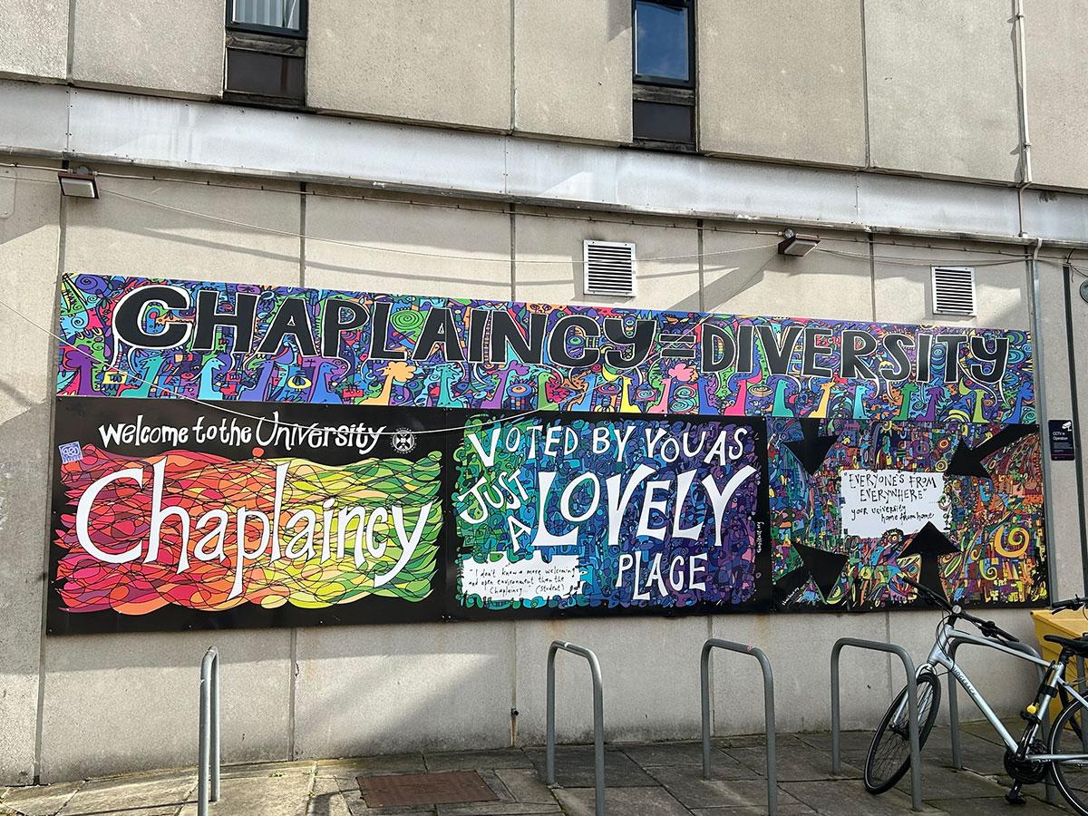 The brightly coloured sign of the Chaplaincy building at 1 Bristo Square.