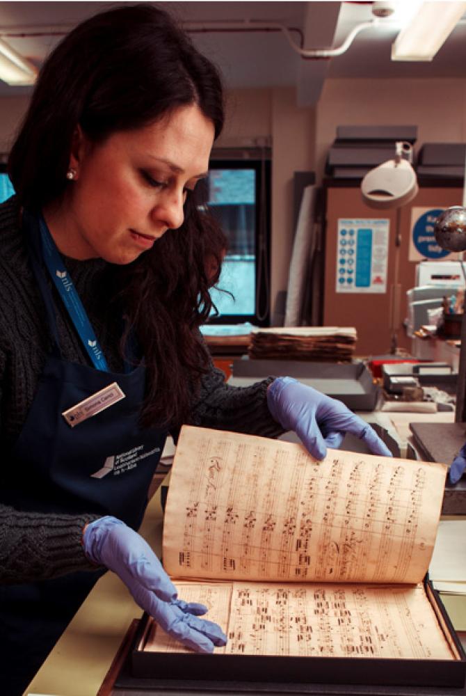 Simona Cenci working with sheet music in the library