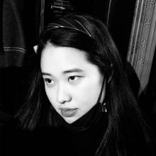 A black and white photo of a person with long dark hair