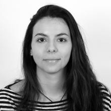 A black and white photo of a person with long dark hair