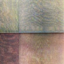 A close up of a painting featuring four sections of different colours - blue, orange, red and green.