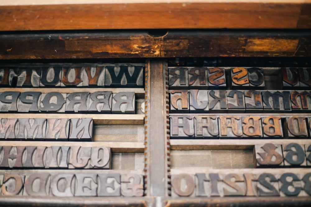 Drawers showing metal letters and numbers that can be used as part of the printmaking process