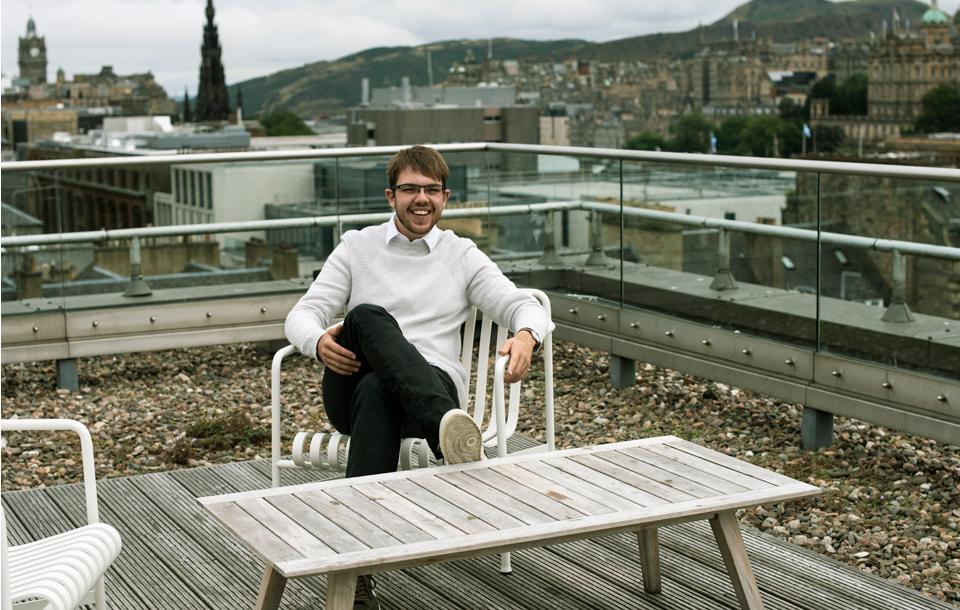 Alexander James Van Der Byl on a rooftop terrace looking over the city of Edinburgh
