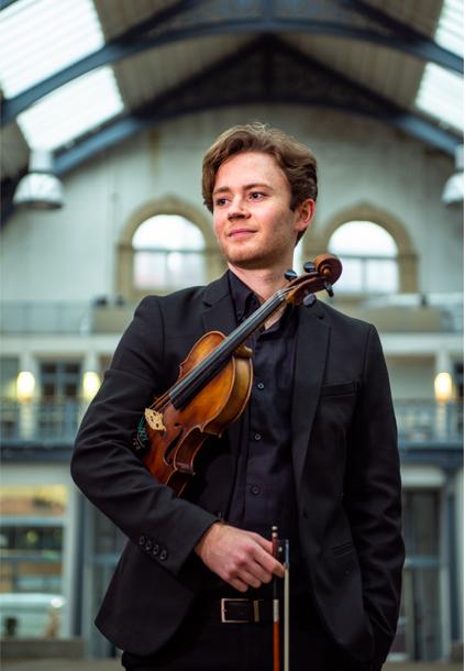 Andrew Taheny holding a violin