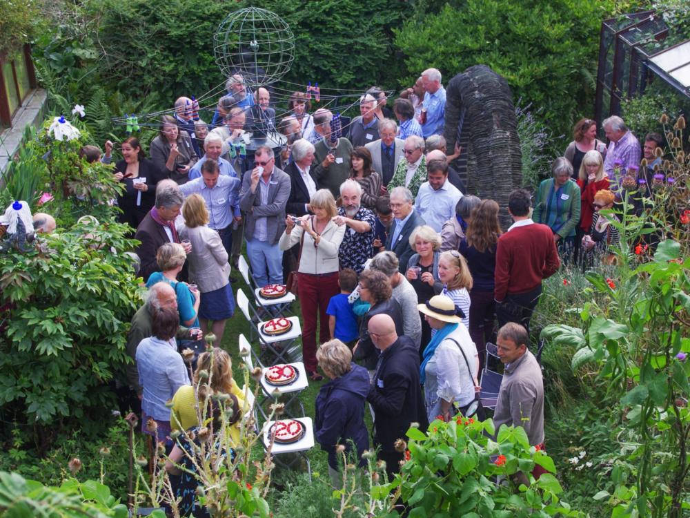 A group of people in a garden party.