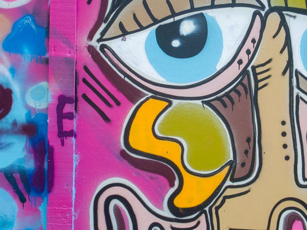 A close up on some brightly coloured graffiti artwork