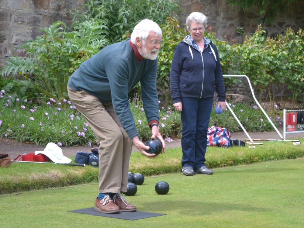 Two people playing lawn bowls
