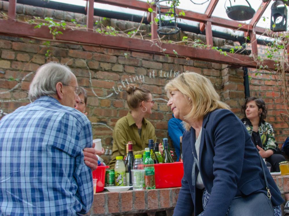 A group of people sitting down and chatting