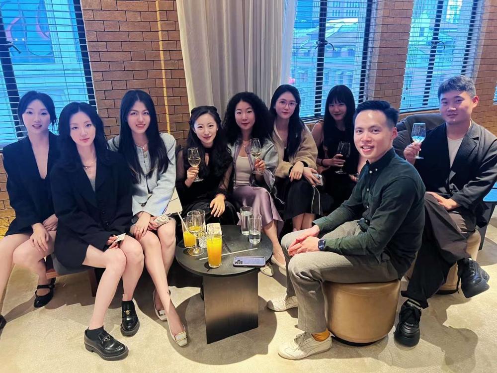 A large group of alumni, sitting down and smiling at the camera