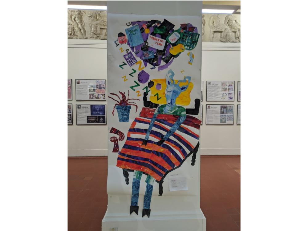 One of the Sculpture Hall columns decorated with a colourful collage of an animal asleep in bed. Above it, in its dreams are lots of objects including a dissertation, bottle of Fairy liquid, and a calculator