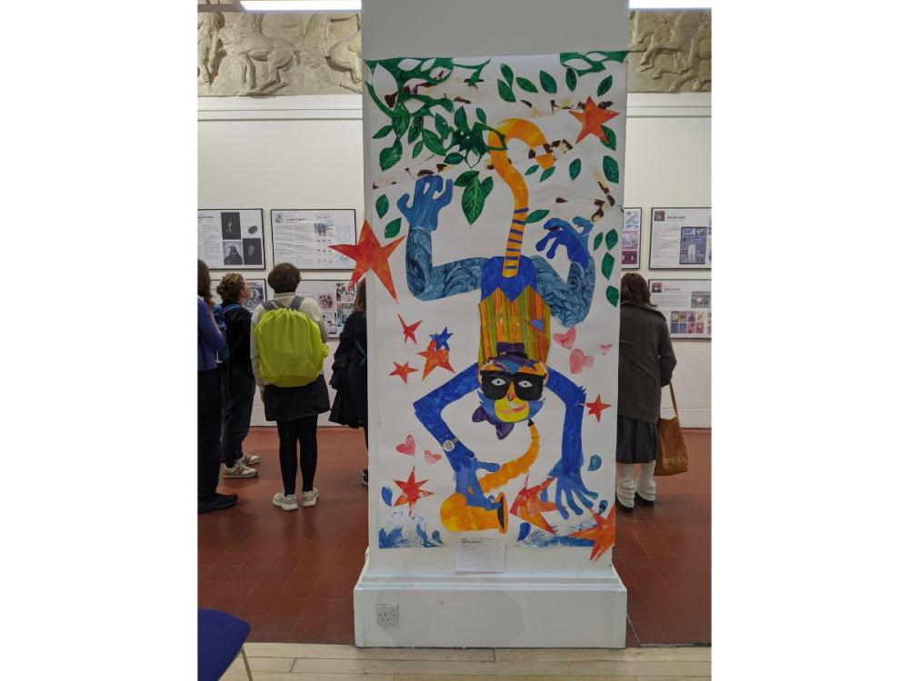 One of the Sculpture Hall columns, decorated with a colourful illustration of a monkey, hanging upside down, holding a saxophone