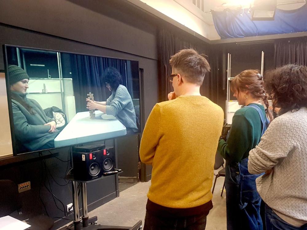 Cinematography tutor and students reviewing their camera exercise at the Camera Workshop