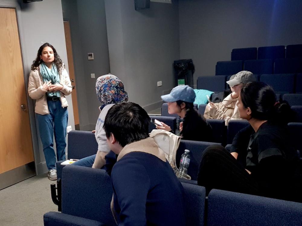 Student presenting her story structure to other students at a semina