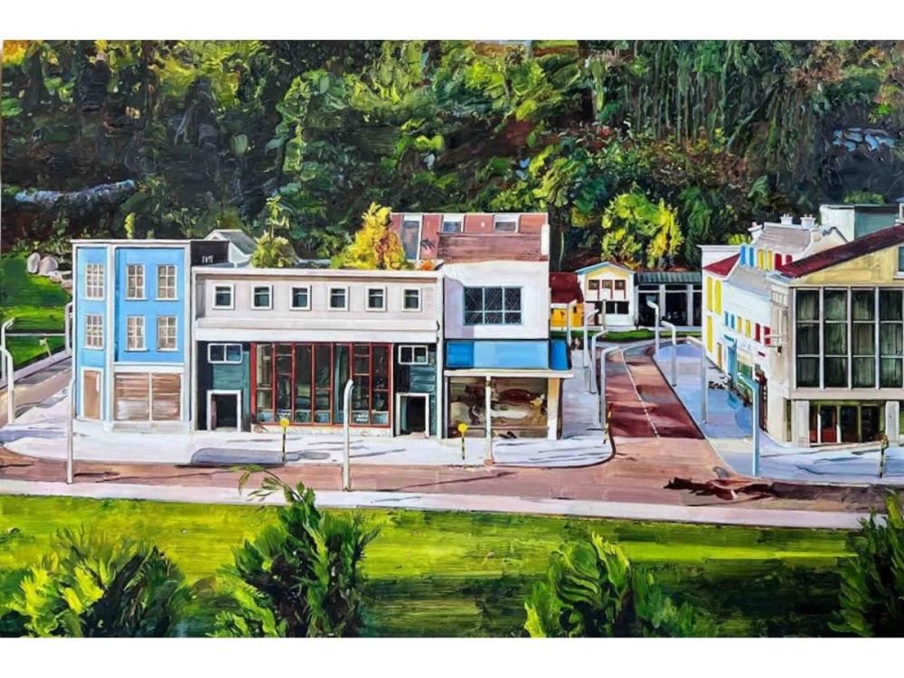 An oil painting of a streetscape with several commercial and residential buildings. Behind the buildings is a vibrant wall of green forest, in front is a grassy area with trees.