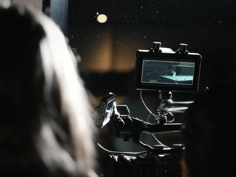 Close up of actor filming a scene on a pool table