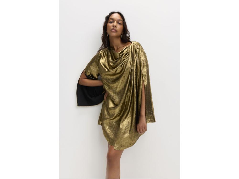 A model wears Casey's gold mini dress. It is heavily pleated at one shoulder, giving shape and texture across the whole body of the dress.