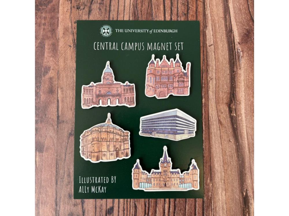 A piece of green card with five magnets on it, featuring illustrations of Old College, Teviot Row House, McEwan Hall, Main Library and Edinburgh Futures Institute. Text on the card says 'Central Campus Magnet Set' and 'Illustrated by Ally McKay'