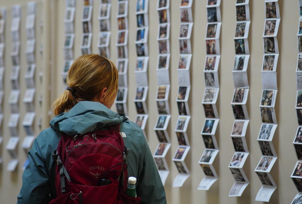 a woman looking at a photo installation