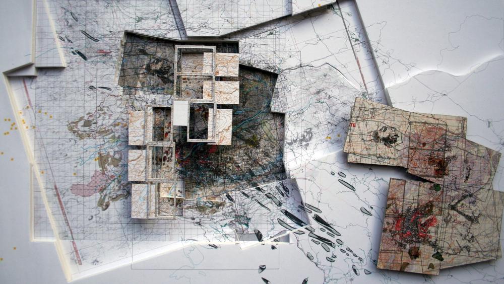 Card model, made with printed drawings of an urban landscape, composed as an excavation. 