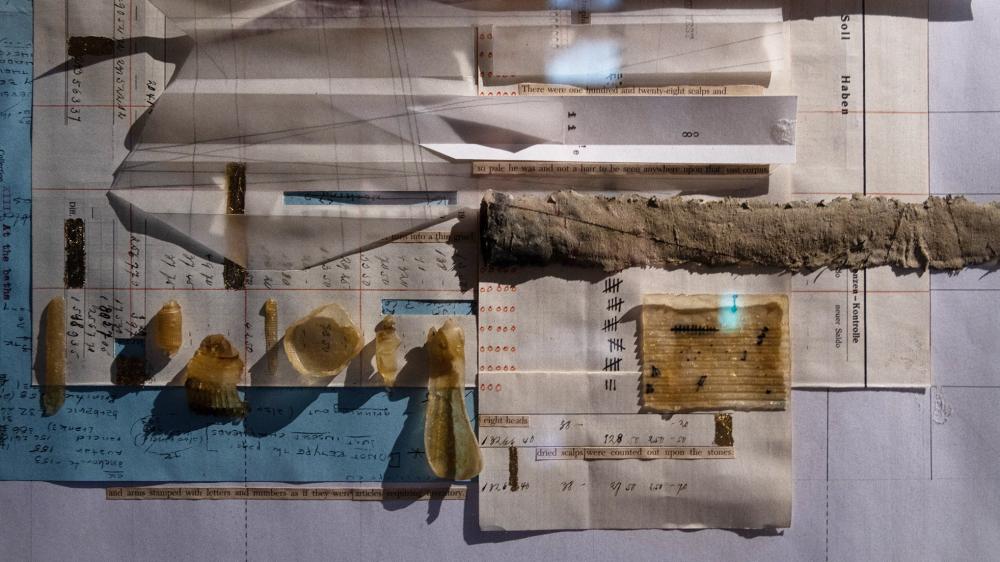 Close-up photograph of a collage drawing, combining field recordings, material samples, hand-written notes, and typed text.
