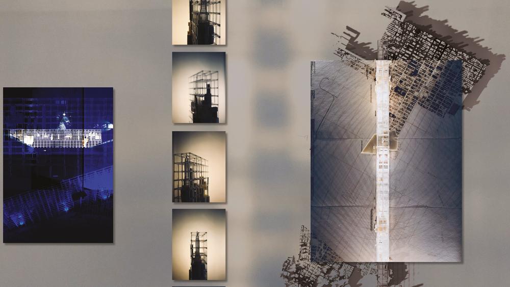 A photograph of an exhibition, showing various views of a model, an elevation drawing, and a site plan.    