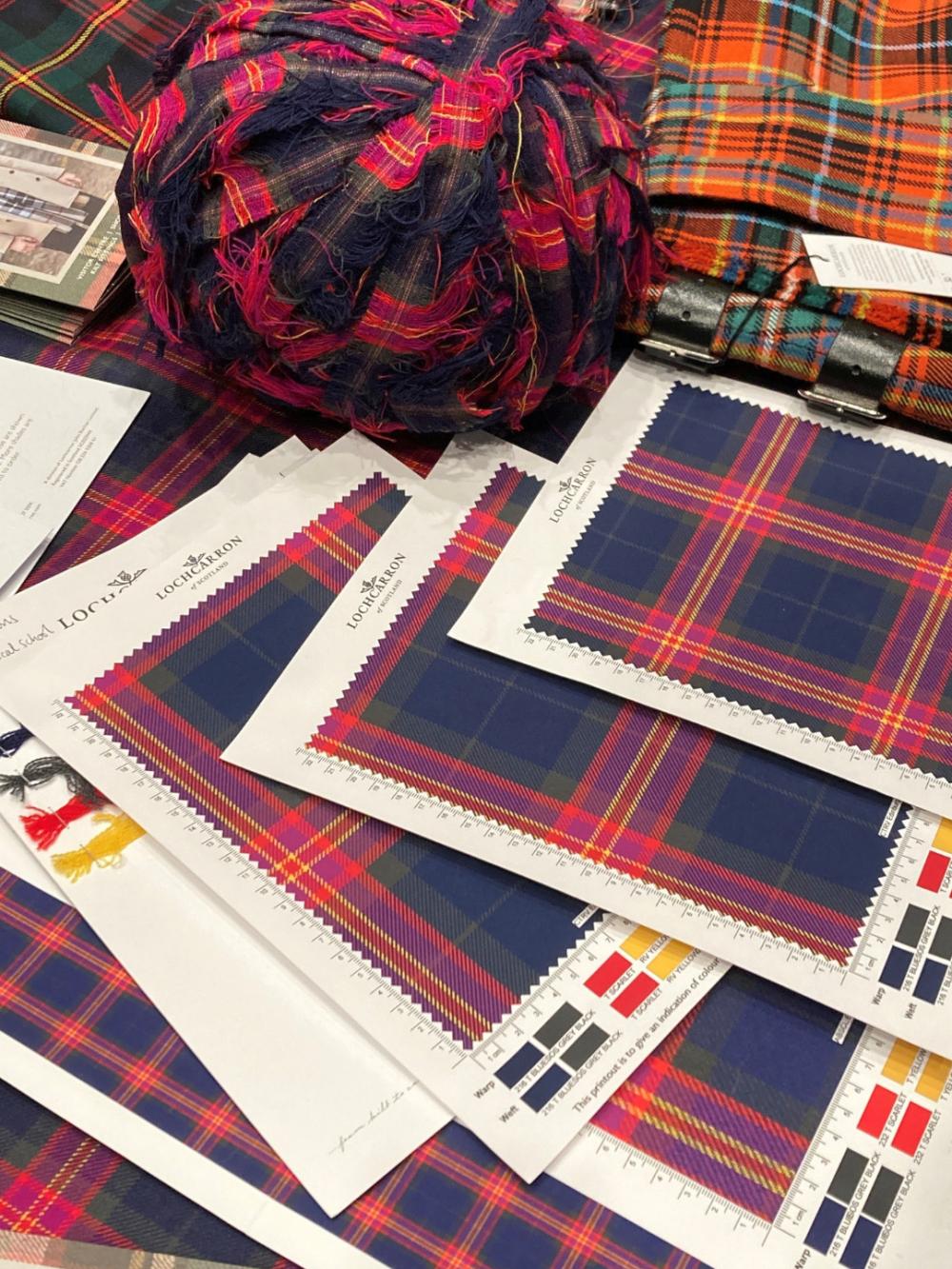 Swatches of the tartan on white card