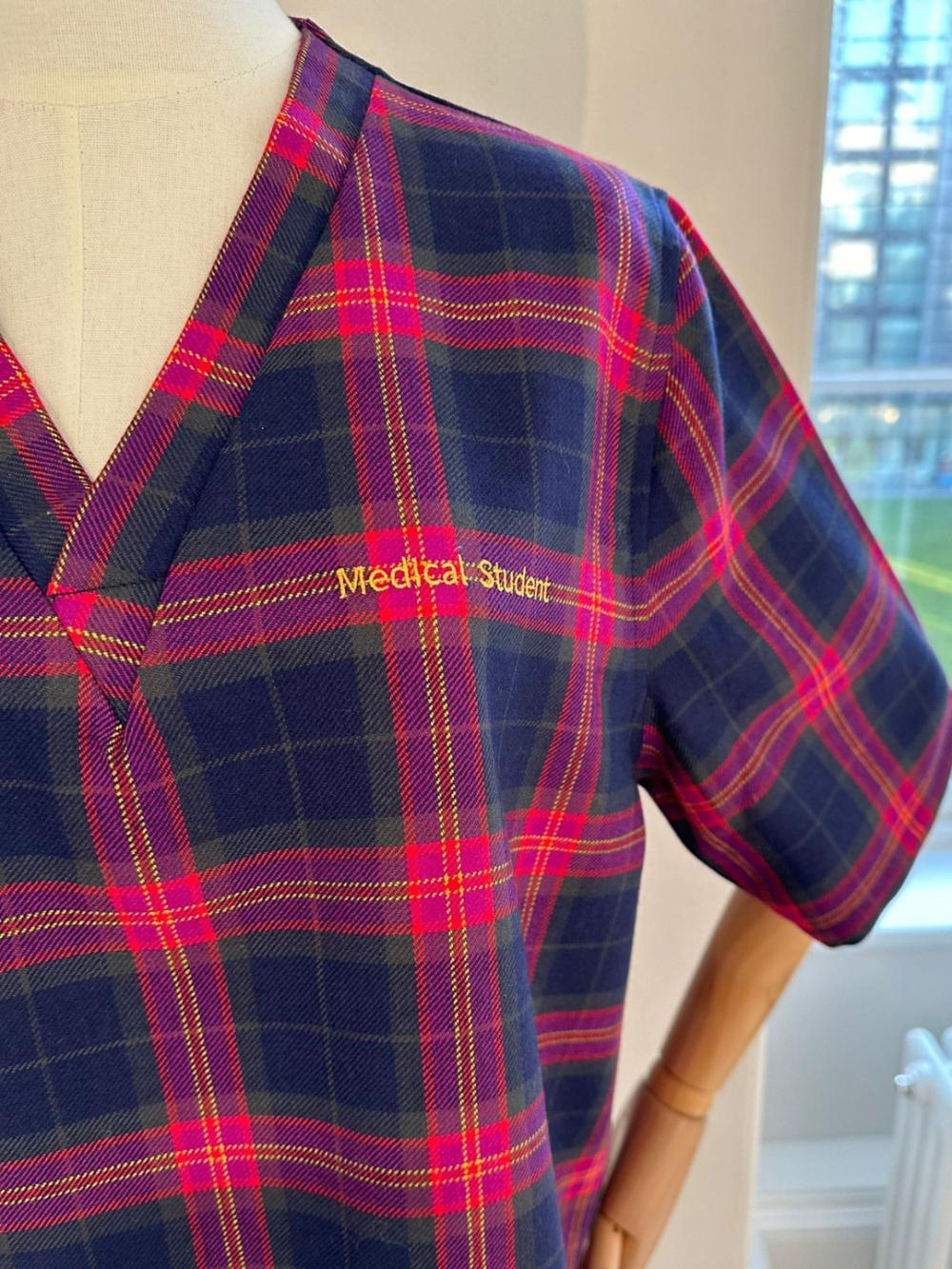 Medical scrubs made of the tartan - close up of the shoulder